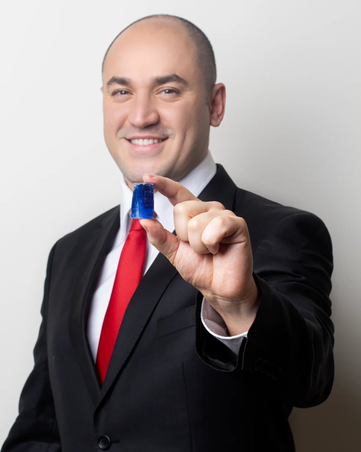 Oros, founder of Indigo Salt, holding an indigo crystal